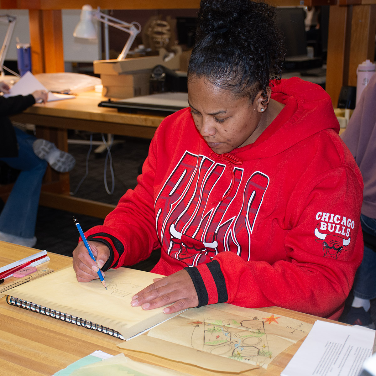 Black, female CCD Architectural Technologies student creating a floorplan