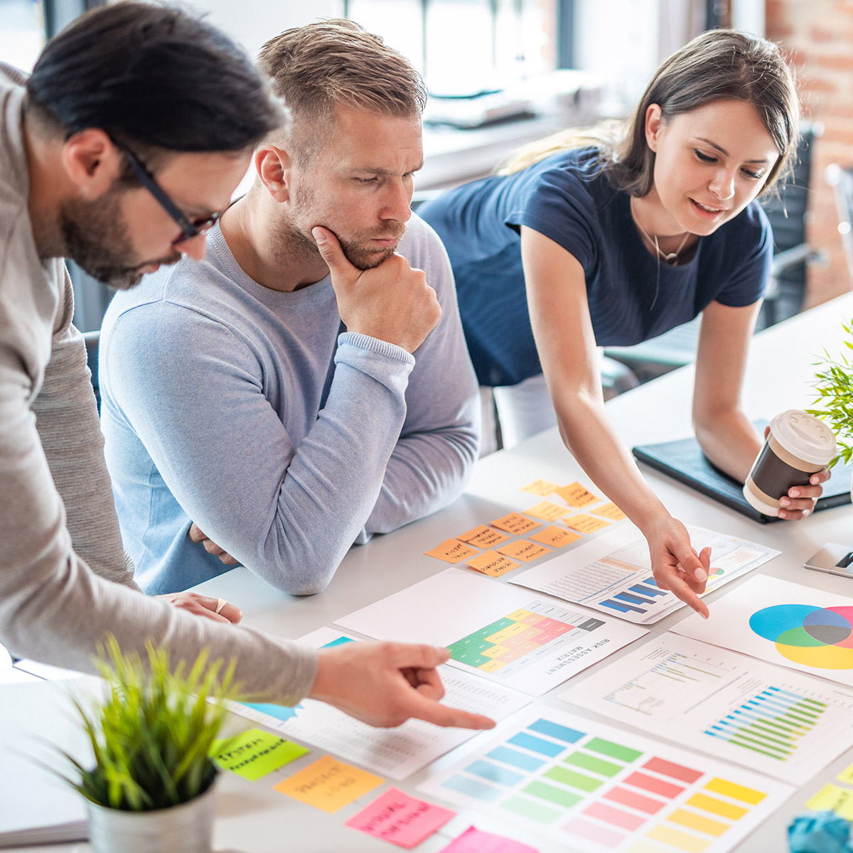 CCD Business students examining charts and graphs