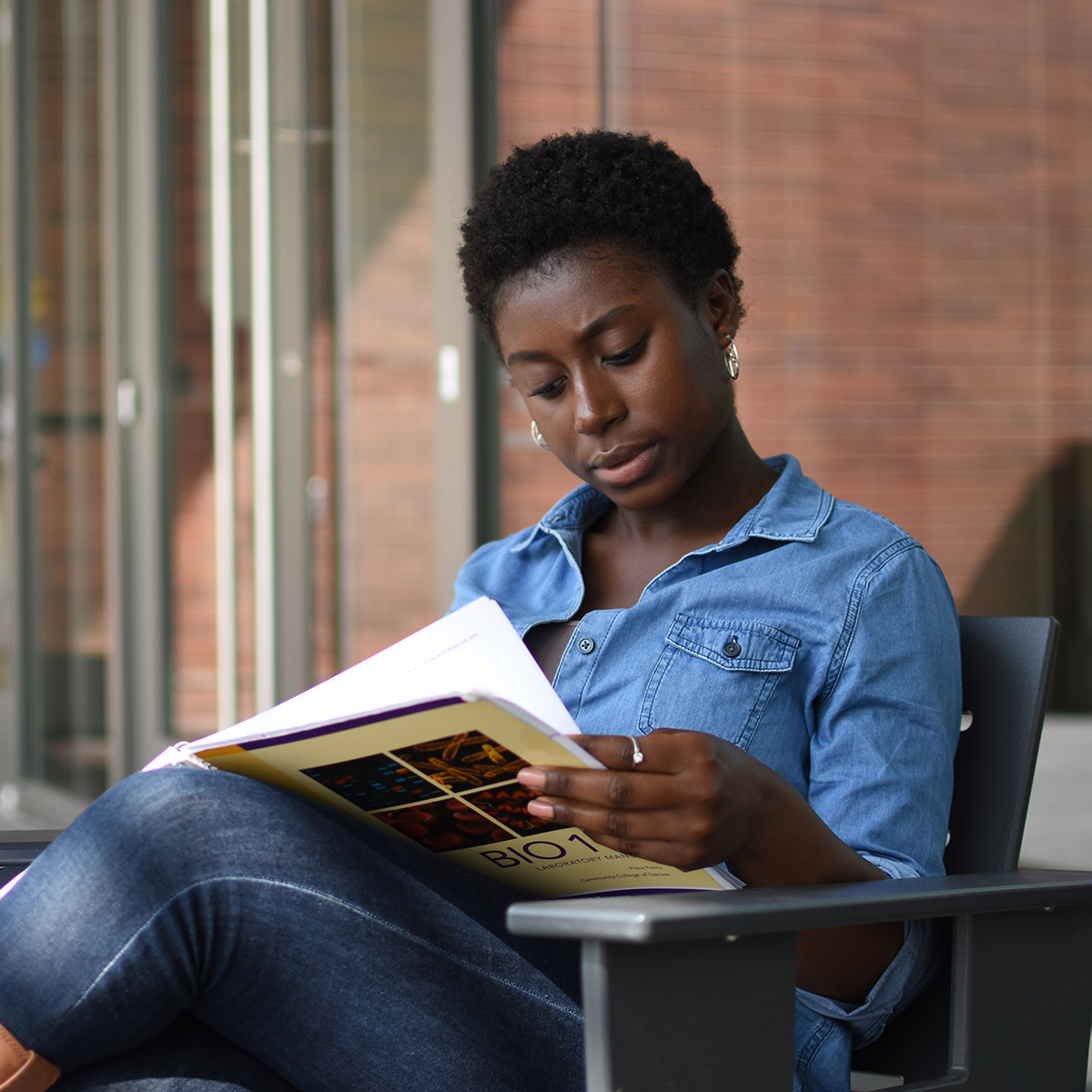 female CCD student reading a biology textbook