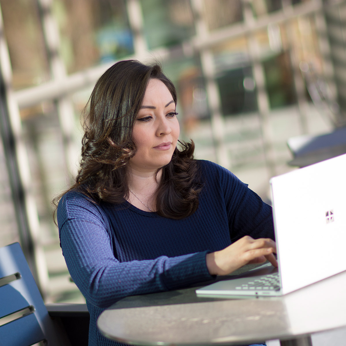 female CCD student working at a laptop