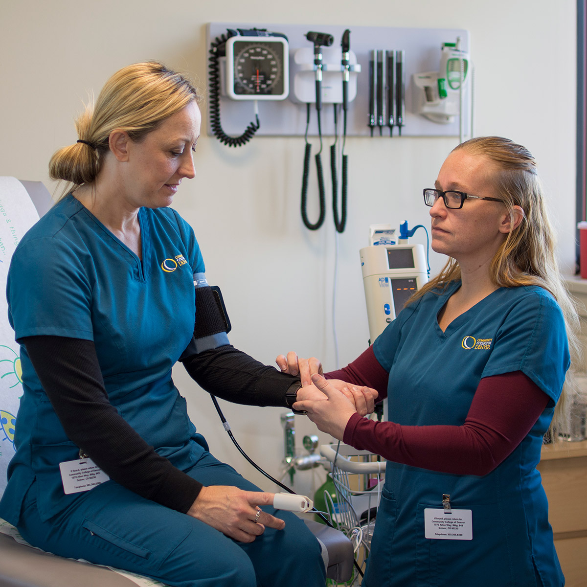 CCD Medical Assistant student practicing taking blood pressure on another student
