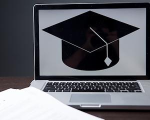 Graduation cap on laptop screen 