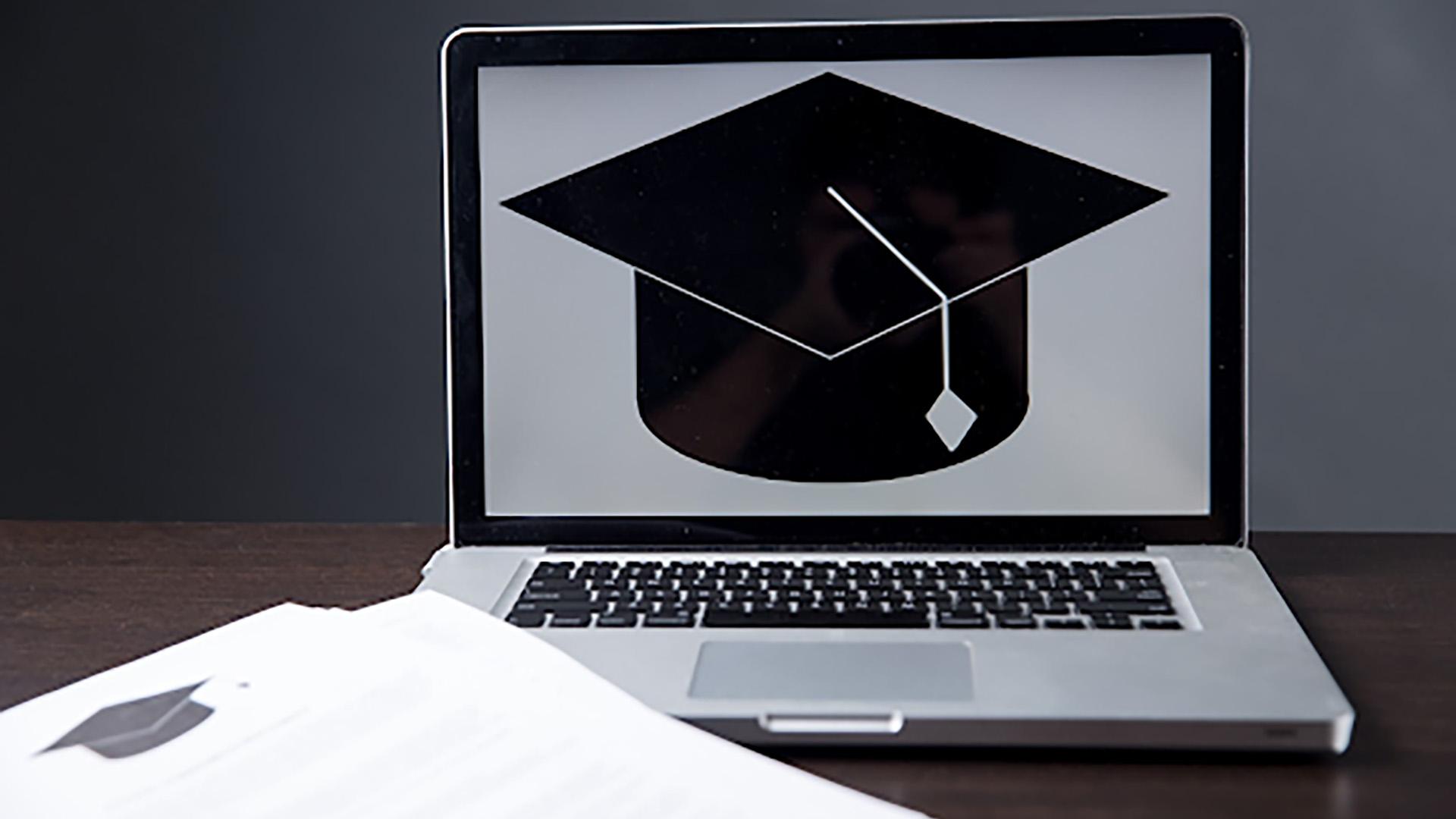 Graduation cap on laptop screen 